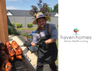 Chef Carlos at Haven Homes poses for a picture outside on the patio with barbecue.