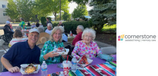 Three people sit together at a table enjoying refreshments at Cornerstone Assisted Living's 2024 Night to Unite.