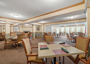 Spacious dining room set with tables and chairs for restaurant-style meals in a senior living community.