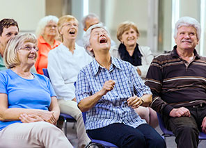 Group of older adults seated together participating in a social activity, representing community engagement like The Pines of Richfield in Richfield, Minnesota