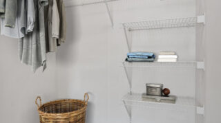 Walk-in closet with hanging clothes, wire shelving, storage space, and woven laundry basket at The Pines of Richfield in Richfield, Minnesota